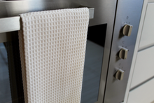 Load image into Gallery viewer, Towel hanging on oven door in the kitchen