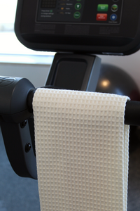 Towel hanging on handle of exercise machine in the gym.